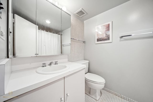 bathroom with tile patterned flooring, vanity, toilet, and a shower with shower curtain