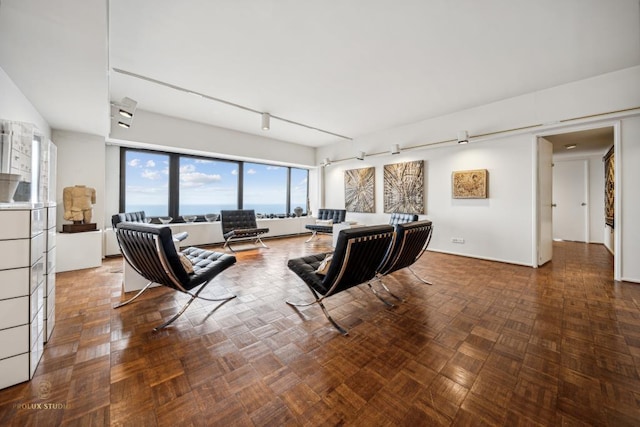 living room with track lighting and parquet floors