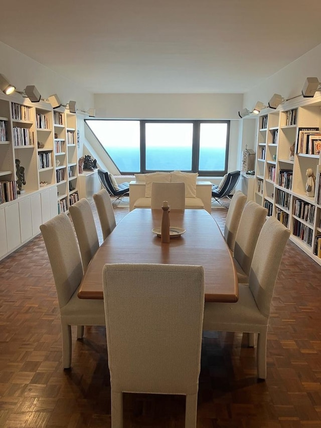 dining room featuring dark parquet flooring