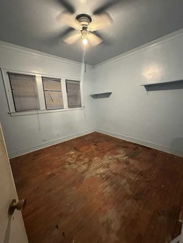 spare room with ceiling fan, dark wood-type flooring, and ornamental molding