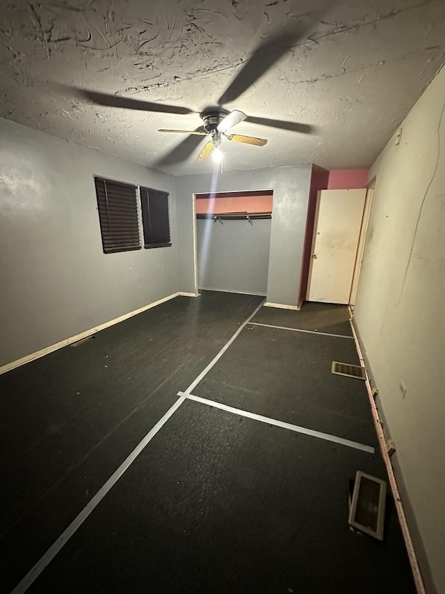 unfurnished bedroom with a textured ceiling and ceiling fan