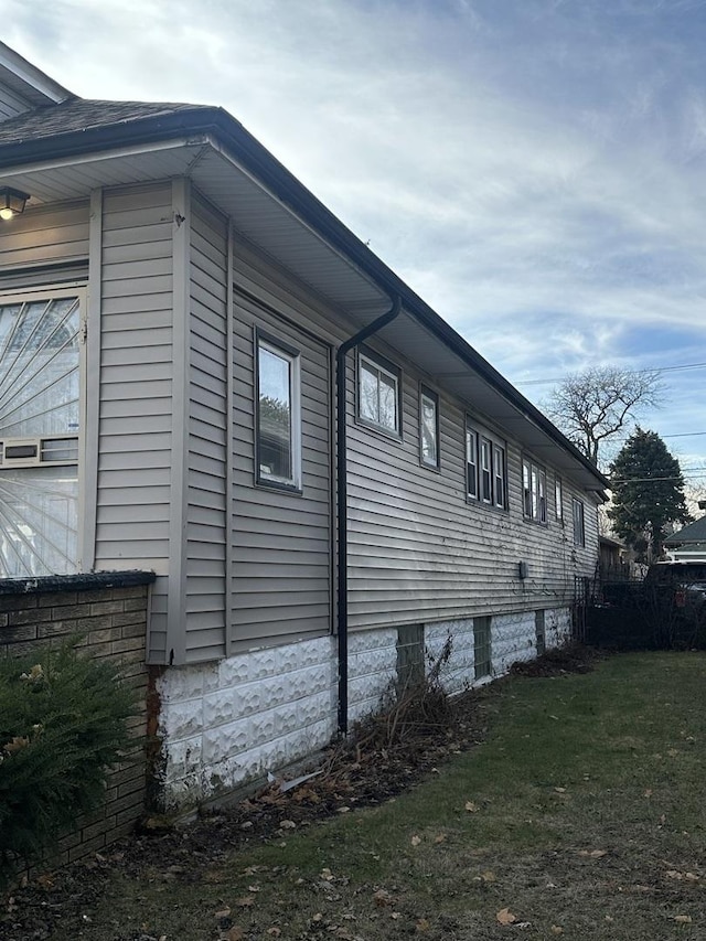 view of side of home featuring a lawn