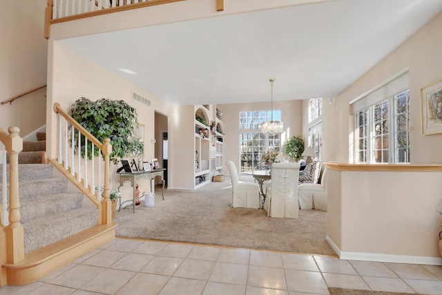 dining room with a notable chandelier, plenty of natural light, and light tile patterned floors