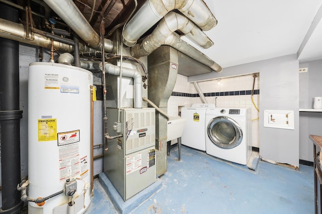 interior space featuring washing machine and dryer, heating unit, gas water heater, and sink