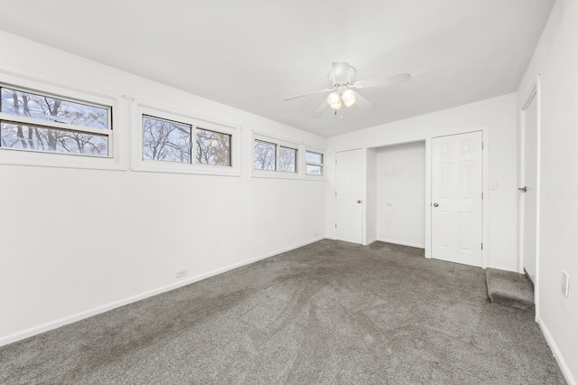 unfurnished bedroom featuring ceiling fan and dark colored carpet