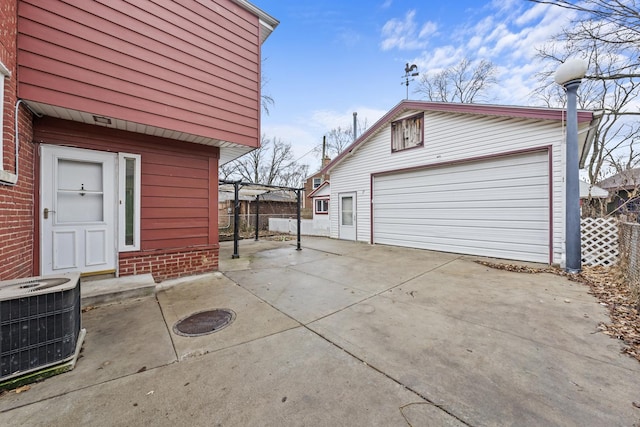 view of home's exterior with central AC unit, a garage, and an outdoor structure