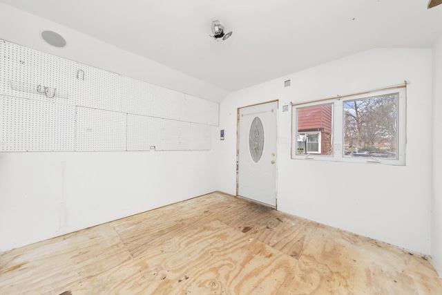 foyer entrance featuring vaulted ceiling