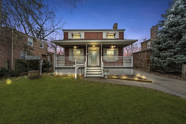 view of front of property with a yard and a porch