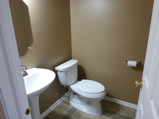 bathroom with tile patterned flooring, toilet, and sink