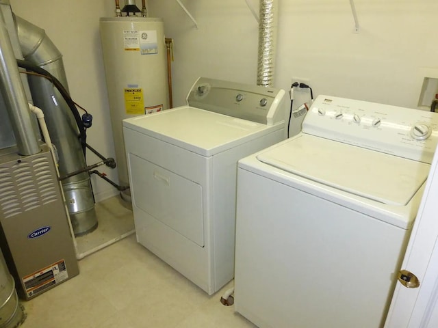 laundry room featuring washing machine and clothes dryer and gas water heater