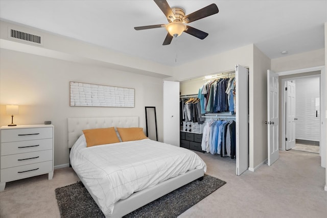 carpeted bedroom with ceiling fan and a closet