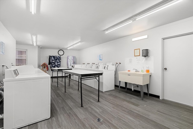 laundry room featuring hardwood / wood-style flooring and washing machine and clothes dryer