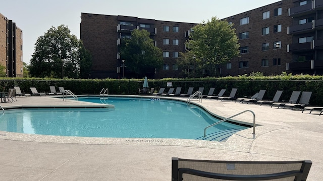 view of swimming pool with a patio