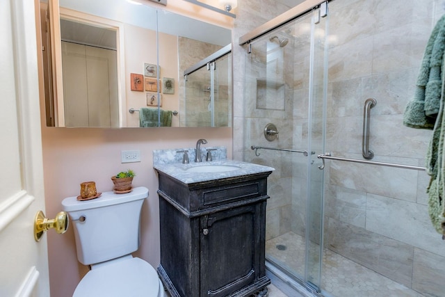 bathroom featuring vanity, toilet, and walk in shower