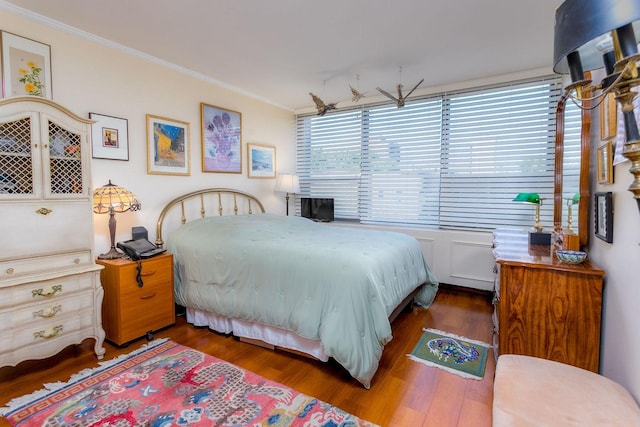 bedroom featuring dark hardwood / wood-style flooring and ornamental molding