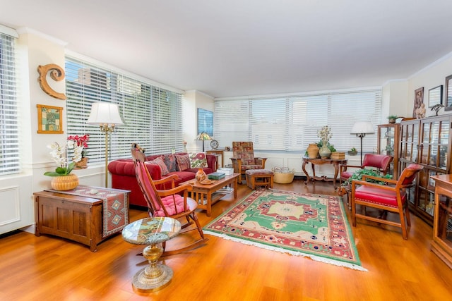 living room with ornamental molding and hardwood / wood-style flooring