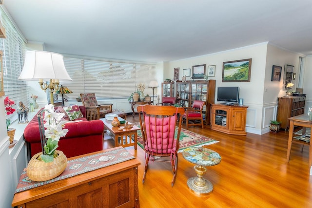 living room featuring hardwood / wood-style flooring and crown molding