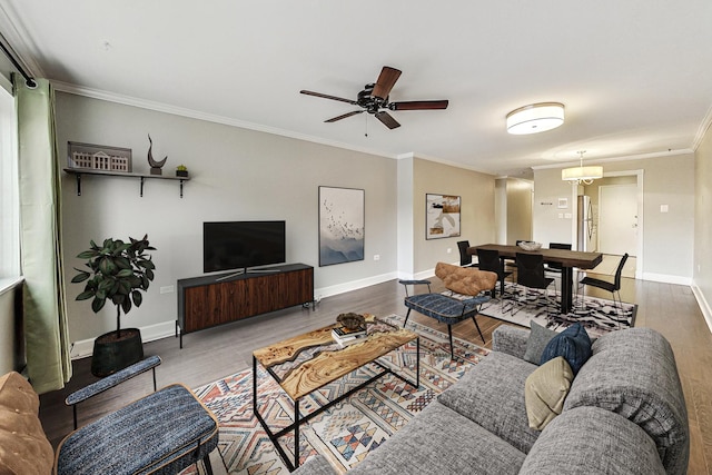 living room featuring hardwood / wood-style flooring, ceiling fan, and crown molding