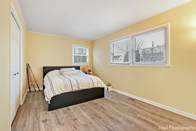 bedroom featuring hardwood / wood-style floors and a closet