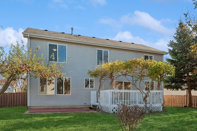 back of house with a yard and a deck