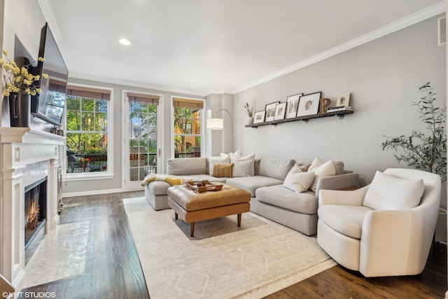 living room with a fireplace, ornamental molding, and hardwood / wood-style flooring