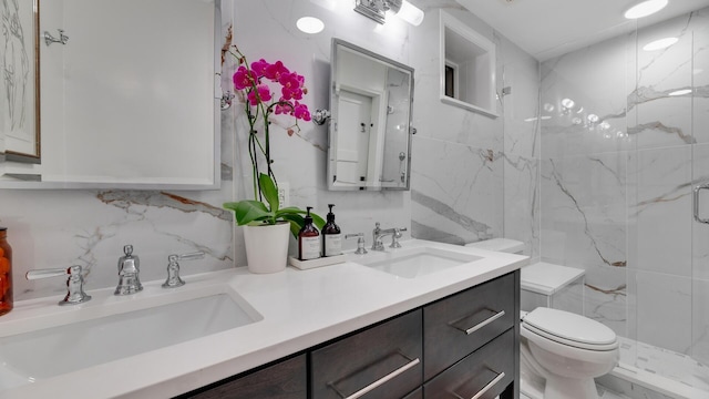 bathroom with tile walls, toilet, walk in shower, decorative backsplash, and vanity