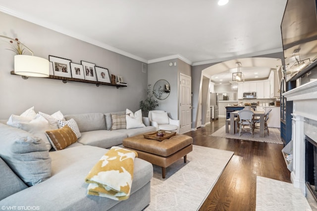 living room with ornamental molding and dark wood-type flooring