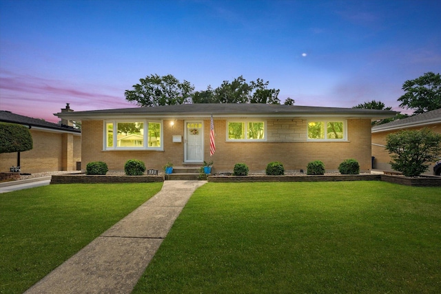 view of front of home with a lawn