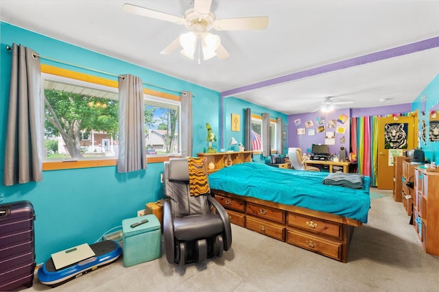 bedroom with ceiling fan and light carpet