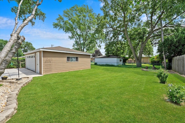 view of yard with a garage and an outdoor structure