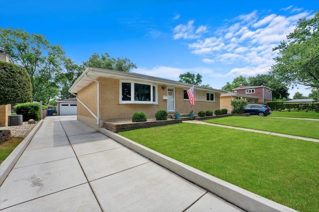 single story home with an outbuilding, central air condition unit, a garage, and a front yard