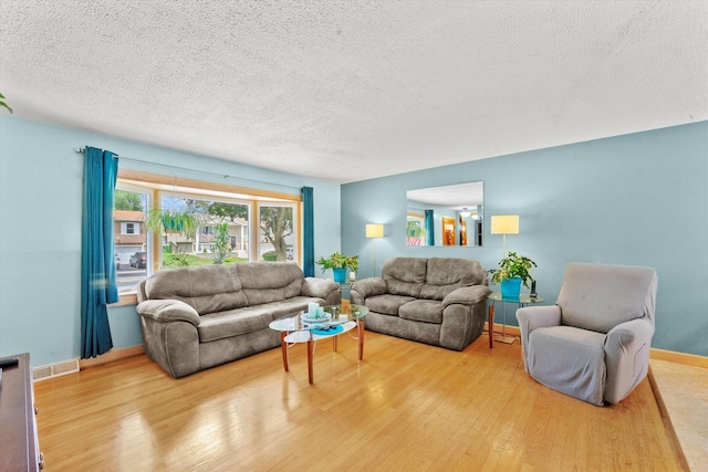 living room featuring hardwood / wood-style flooring and a textured ceiling