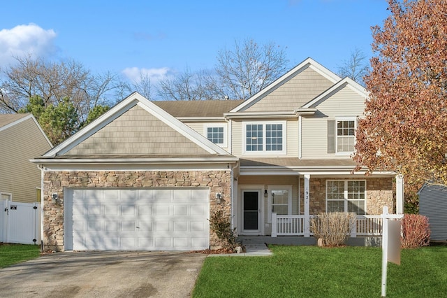 view of front facade featuring a garage, a porch, and a front yard