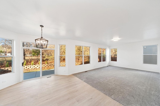 unfurnished sunroom with an inviting chandelier and a wealth of natural light