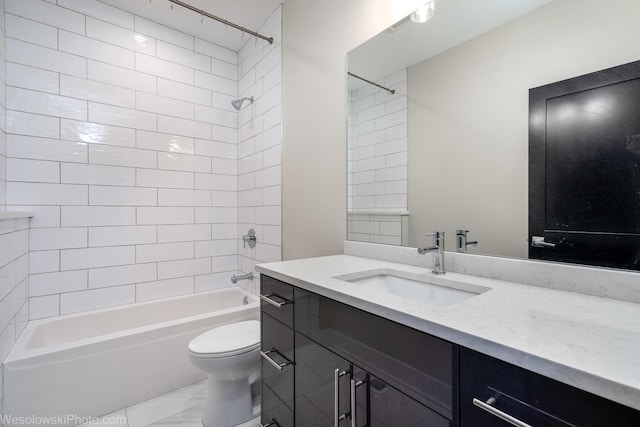 full bathroom with vanity, tiled shower / bath combo, and toilet