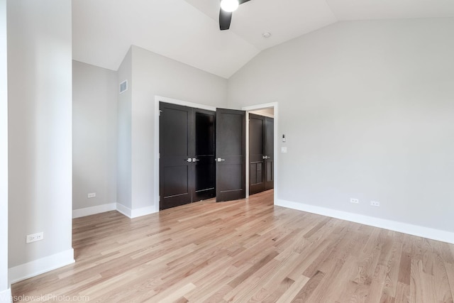 unfurnished bedroom featuring a closet, light hardwood / wood-style flooring, ceiling fan, and lofted ceiling