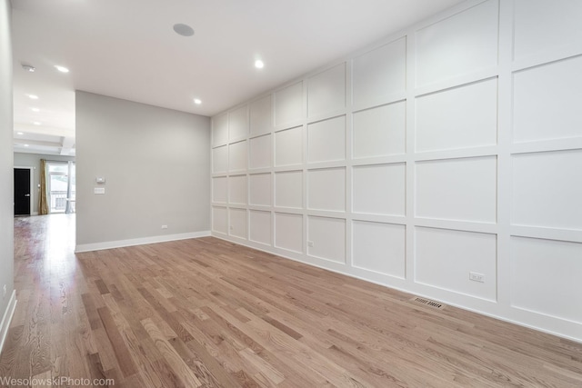 spare room with light hardwood / wood-style flooring