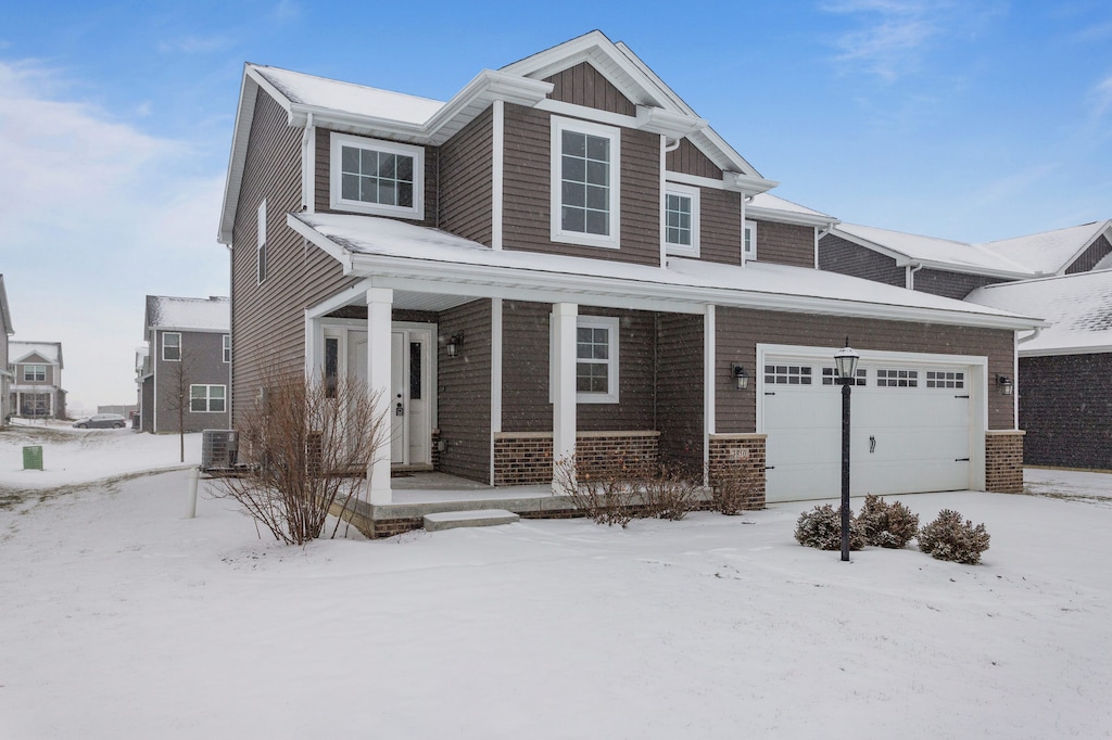 view of front of home with cooling unit and a garage