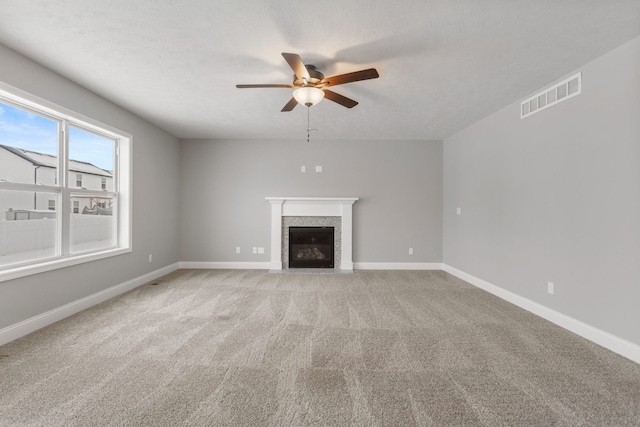 unfurnished living room with ceiling fan and light carpet