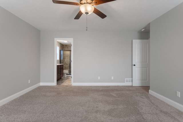 carpeted empty room featuring ceiling fan