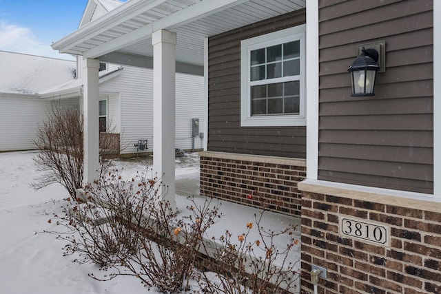 view of snow covered property entrance