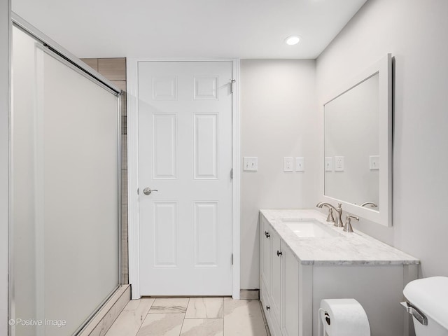 bathroom featuring vanity, toilet, and walk in shower