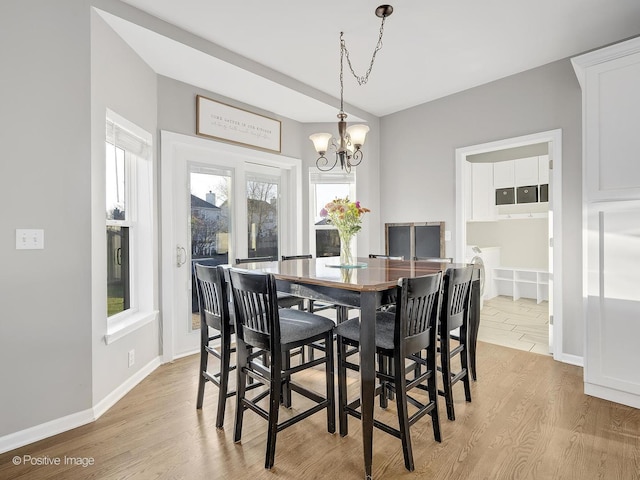 dining room featuring a chandelier and light wood-type flooring