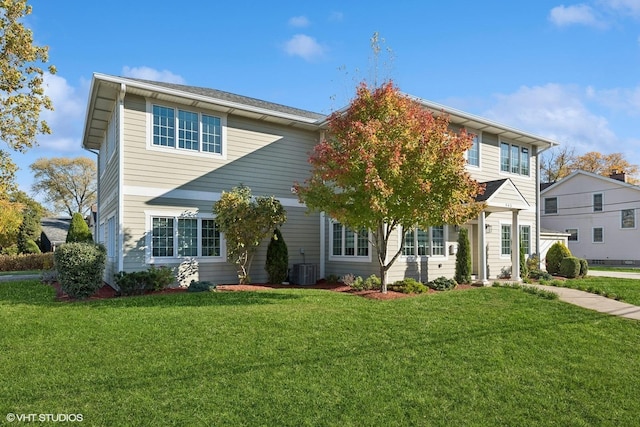 view of front of house with cooling unit and a front yard