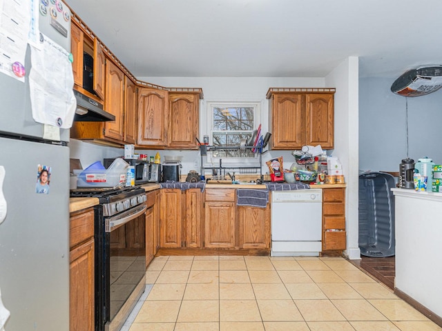 kitchen featuring white appliances and light tile patterned flooring