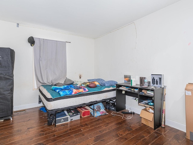 bedroom with dark wood-type flooring