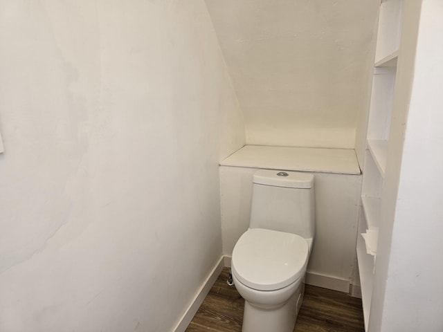 bathroom with hardwood / wood-style floors and toilet