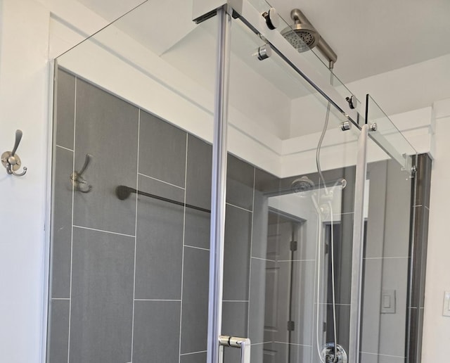 bathroom with a shower with door