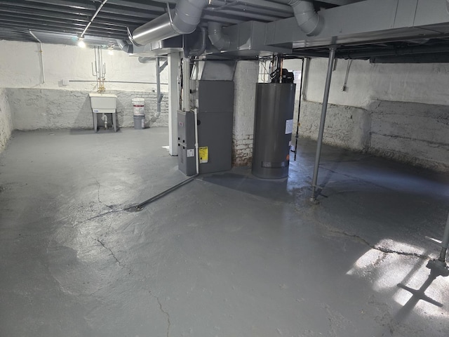 basement featuring gas water heater, heating unit, and sink