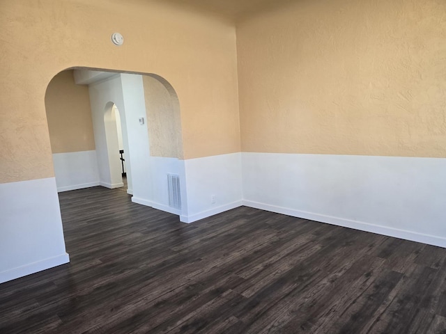 unfurnished room featuring dark hardwood / wood-style floors